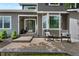 Charming front porch with rocking chairs, creating a welcoming entrance to this lovely home at 7027 Chestnut Hill St, Highlands Ranch, CO 80130