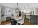 Charming kitchen featuring white cabinetry, marble counters, and stainless steel appliances at 7027 Chestnut Hill St, Highlands Ranch, CO 80130