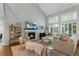 Living room showcasing fireplace, large windows, neutral colors, and comfortable furniture at 7027 Chestnut Hill St, Highlands Ranch, CO 80130