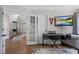 Open-concept living room with hardwood floors, seamlessly blending style and comfort for modern living at 7027 Chestnut Hill St, Highlands Ranch, CO 80130