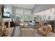Bright living room features a fireplace, neutral colors, large windows, and comfortable seating at 7027 Chestnut Hill St, Highlands Ranch, CO 80130