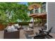Stunning backyard patio with an elevated deck, a cozy fire pit, and ample seating for outdoor enjoyment and entertaining at 7027 Chestnut Hill St, Highlands Ranch, CO 80130