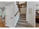 Carpeted staircase with wooden railing, seamlessly connecting the home's upper and lower levels at 7027 Chestnut Hill St, Highlands Ranch, CO 80130