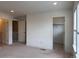 Open bedroom showcasing two doorways, neutral walls and carpet, and natural light at 8311 Parkland St, Broomfield, CO 80021