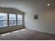 Sunlit bedroom featuring three large windows and neutral carpeting at 8311 Parkland St, Broomfield, CO 80021