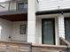 Modern townhome exterior featuring wood accents, balcony, and front door at 8311 Parkland St, Broomfield, CO 80021