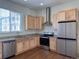 Bright kitchen features stainless steel appliances, granite counters, and light wood cabinets at 8311 Parkland St, Broomfield, CO 80021