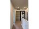 Conveniently located laundry closet with stacked washer and dryer, and shelving for additional storage at 8311 Parkland St, Broomfield, CO 80021
