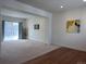 Bright living room with a sliding glass door and neutral carpet at 8311 Parkland St, Broomfield, CO 80021
