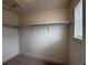 Spacious walk-in closet with ample shelving and a window for natural light at 8311 Parkland St, Broomfield, CO 80021