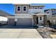 Charming two-story home featuring stone accents, a two-car garage, and a well-manicured front yard at 210 Lark Sparrow Way, Bennett, CO 80102