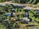 An aerial view of a home surrounded by trees and a winding road showing the property's layout at 28251 Shadow Mountain Dr, Conifer, CO 80433