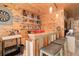 Charming bar area with wood accents, decorative dartboard, and a fully stocked bar at 28251 Shadow Mountain Dr, Conifer, CO 80433