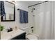 Cozy bathroom with a shower-tub combination, dark vanity, and patterned towels at 28251 Shadow Mountain Dr, Conifer, CO 80433