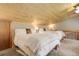 Bedroom features two beds with wood frames, plush bedding and wood plank ceiling at 28251 Shadow Mountain Dr, Conifer, CO 80433