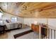 This bedroom boasts a stunning wood ceiling, soft carpet, and natural light at 28251 Shadow Mountain Dr, Conifer, CO 80433