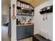 Charming coffee bar featuring cabinets, a coffee maker, decor, and shelving at 28251 Shadow Mountain Dr, Conifer, CO 80433