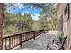 Deck with wood railing, exterior seating, and a wooded view at 28251 Shadow Mountain Dr, Conifer, CO 80433