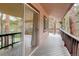 Deck featuring wood floors, wood railing, an exterior view, and a peek into the home at 28251 Shadow Mountain Dr, Conifer, CO 80433