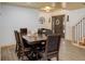 Open concept dining room with wooden table, decorative ceiling, and staircase at 28251 Shadow Mountain Dr, Conifer, CO 80433