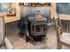 Heating stove near dining area that includes wood walls and tin accent wall at 28251 Shadow Mountain Dr, Conifer, CO 80433