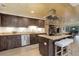 Spacious kitchen with granite counters, wood ceiling, stainless appliances, and center island with seating at 28251 Shadow Mountain Dr, Conifer, CO 80433