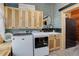 Well-equipped laundry room with wood cabinets, modern washer and dryer, and stylish decor at 28251 Shadow Mountain Dr, Conifer, CO 80433