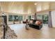Cozy living room with wood floors, a stone fireplace, and scenic backyard views at 28251 Shadow Mountain Dr, Conifer, CO 80433
