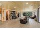 Inviting living room featuring wood accents, a stone fireplace, and expansive natural light at 28251 Shadow Mountain Dr, Conifer, CO 80433