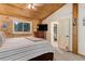 Bedroom featuring a wood ceiling, carpet, a flat-screen TV, and natural light at 28251 Shadow Mountain Dr, Conifer, CO 80433