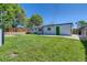 Spacious backyard with lush lawn, a shed, and freshly painted exterior at 9411 Rose Ct, Thornton, CO 80229