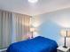 A cozy bedroom featuring a blue comforter and matching lamp shades providing a calm, relaxing ambiance at 9411 Rose Ct, Thornton, CO 80229