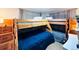 Shared bedroom featuring wooden bunk beds with blue and gray linens and side tables at 9411 Rose Ct, Thornton, CO 80229