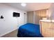 A bedroom equipped with a mounted flat screen TV, providing entertainment right from the comfort of your bed at 9411 Rose Ct, Thornton, CO 80229