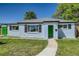 Charming single-story home with a green door, well-manicured lawn, and blue sky overhead at 9411 Rose Ct, Thornton, CO 80229