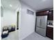 Hallway with a stainless steel refrigerator and access to a bathroom at 9411 Rose Ct, Thornton, CO 80229
