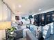 Open living room featuring neutral walls, cozy couches, modern lighting, and stylish decor at 9411 Rose Ct, Thornton, CO 80229