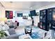 Open living room featuring neutral walls, cozy couches, modern lighting, and stylish decor at 9411 Rose Ct, Thornton, CO 80229
