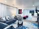 Beautiful living room area with stylish sofas, a glass coffee table, and decoratively framed wall art at 9411 Rose Ct, Thornton, CO 80229
