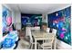A room with a dining table, chairs, and colorful tapestries at 9411 Rose Ct, Thornton, CO 80229