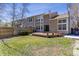 Backyard view of a two-story home with a wooden fence and a well-manicured lawn at 1550 S Syracuse St, Denver, CO 80231