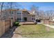 Expansive backyard features a lush lawn, wooden fence, and mature trees at 1550 S Syracuse St, Denver, CO 80231