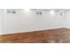 Bright basement space featuring wood-look flooring and small, high windows at 1550 S Syracuse St, Denver, CO 80231