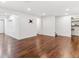 Spacious basement area with wood floors, ample lighting, and access to other areas at 1550 S Syracuse St, Denver, CO 80231
