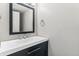 Modern bathroom featuring a sleek vanity with a rectangular mirror and new fixtures at 1550 S Syracuse St, Denver, CO 80231