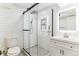 Modern bathroom features a glass door shower with white subway tiles and a sleek vanity at 1550 S Syracuse St, Denver, CO 80231