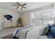 Cozy bedroom boasting a ceiling fan, bay window, and stylish decor with serene and inviting ambiance at 1550 S Syracuse St, Denver, CO 80231