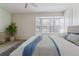 Bright bedroom featuring a large bay window, neutral tones, a ceiling fan, and plush carpet at 1550 S Syracuse St, Denver, CO 80231