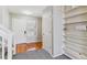 Bright entryway featuring hardwood floors, fresh gray paint, and a convenient storage area at 1550 S Syracuse St, Denver, CO 80231