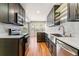 Modern kitchen with stainless steel appliances, sleek countertops, and ample cabinet space at 1550 S Syracuse St, Denver, CO 80231
